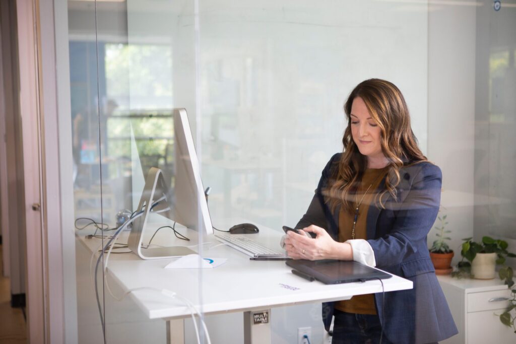 Woman sitting in front of computer in an office space